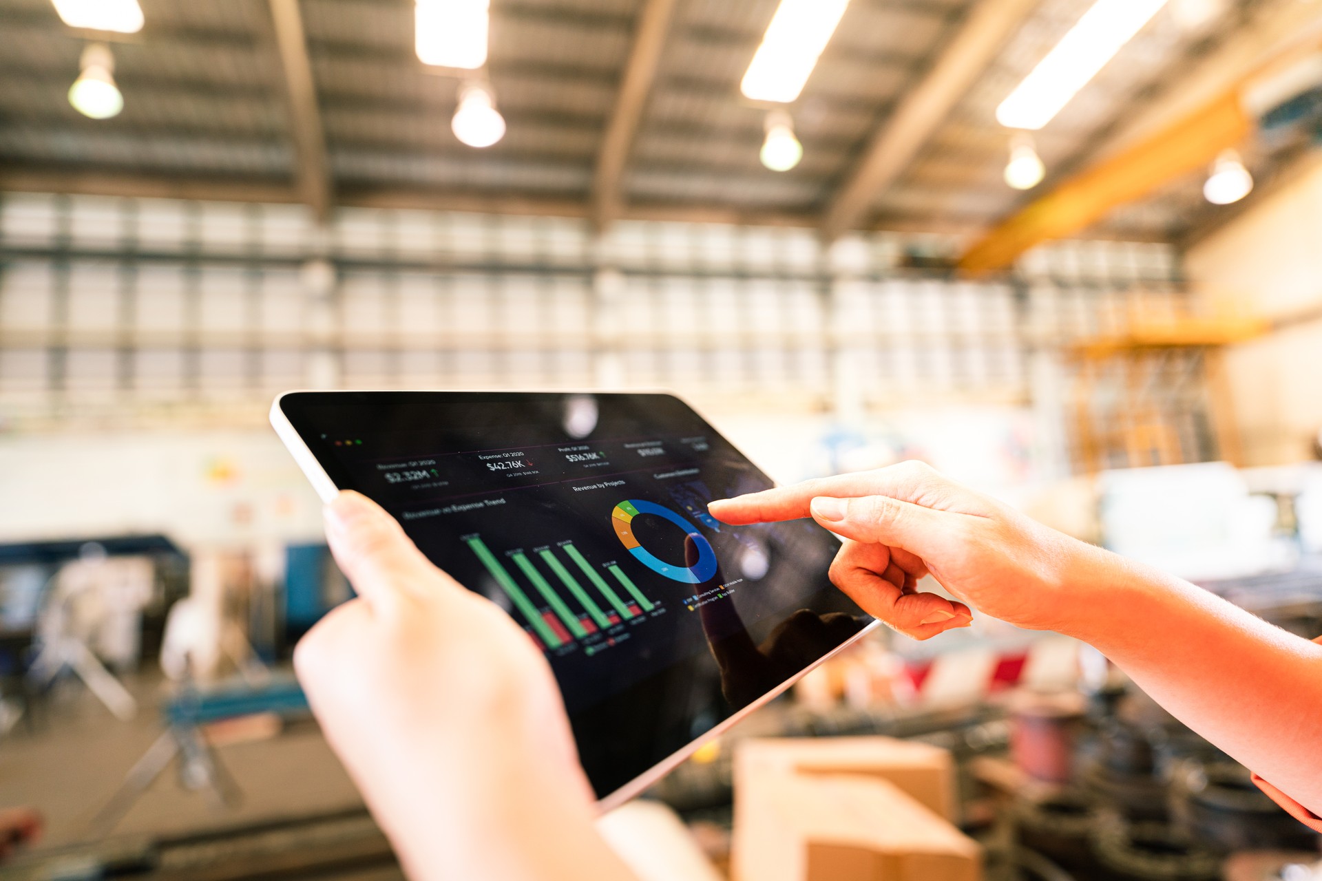 A worker is using tablet to review storage report - Business management and technology concept photo.